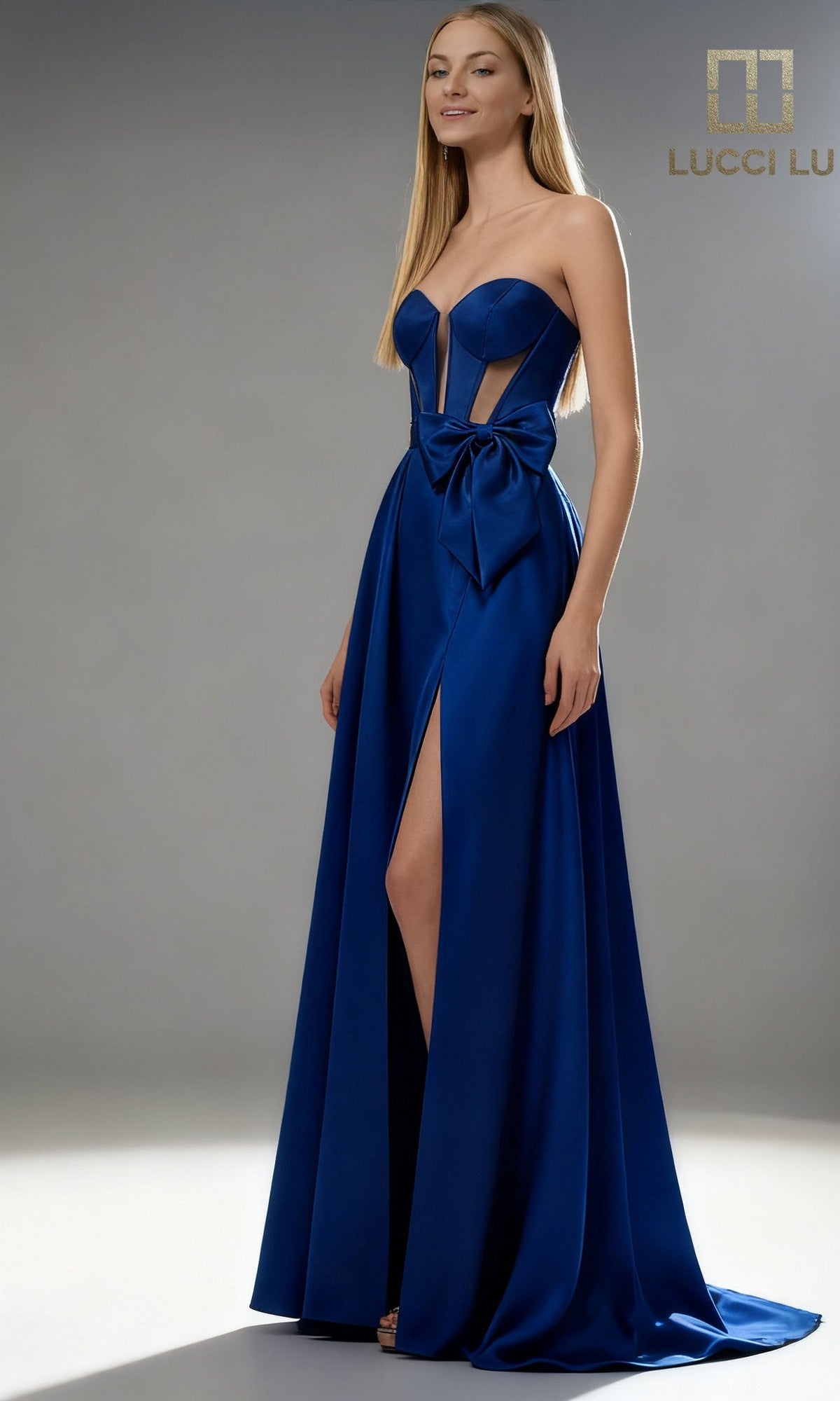 A woman models the Abby Paris 90384 long prom dress in royal, featuring a strapless neckline, front slit, waist bow detail, and semi-sheer corset bodice panels against a plain background.